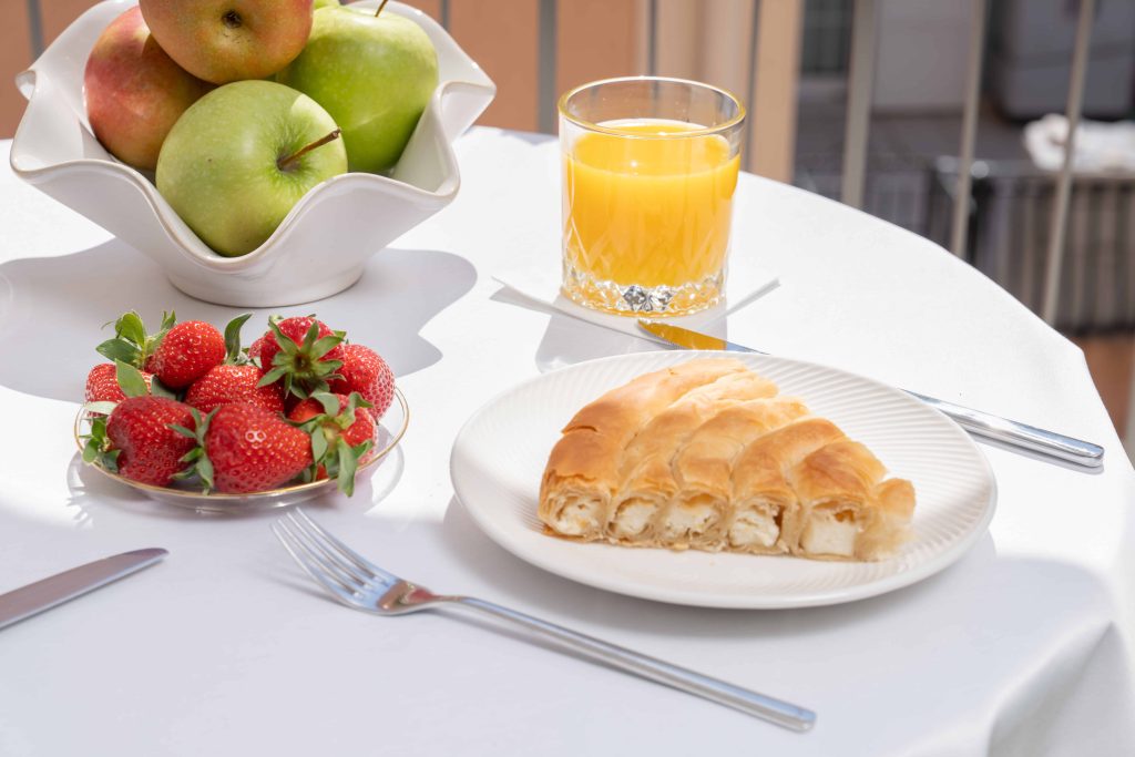 fresh_continental_breakfast_with_a_croissant_orange_juice_and_seasonal_fruit_at_argostoli_bay_apartments